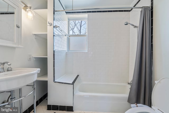 bathroom with tile patterned flooring, toilet, and shower / tub combo