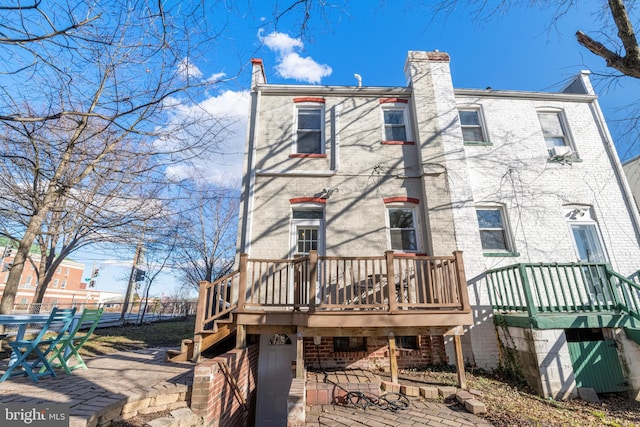 rear view of property with a patio and a deck