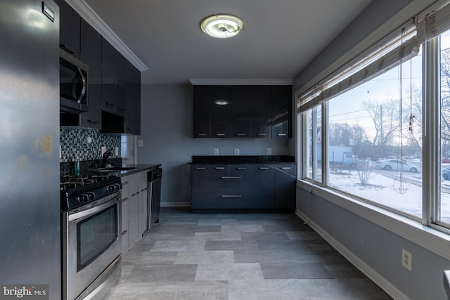 kitchen with tasteful backsplash, sink, and appliances with stainless steel finishes