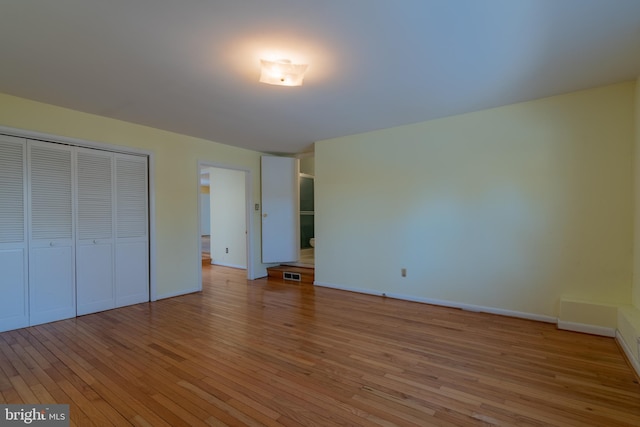 unfurnished bedroom with a closet and light hardwood / wood-style flooring