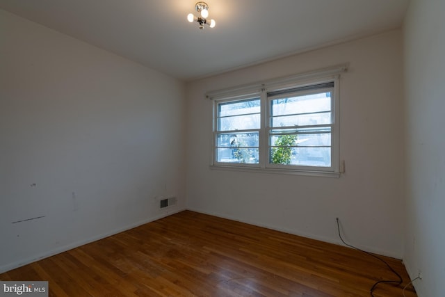 unfurnished room featuring wood-type flooring