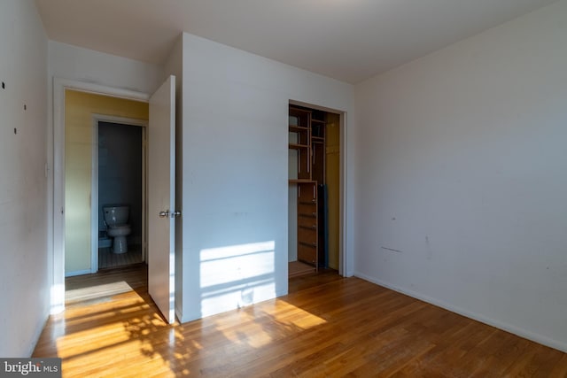 unfurnished bedroom featuring light hardwood / wood-style floors and a closet