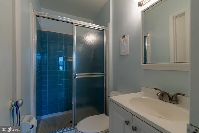 bathroom featuring vanity, toilet, and walk in shower