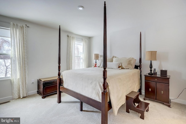 bedroom featuring light carpet