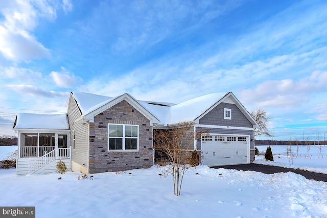 view of front of house with a garage and a sunroom