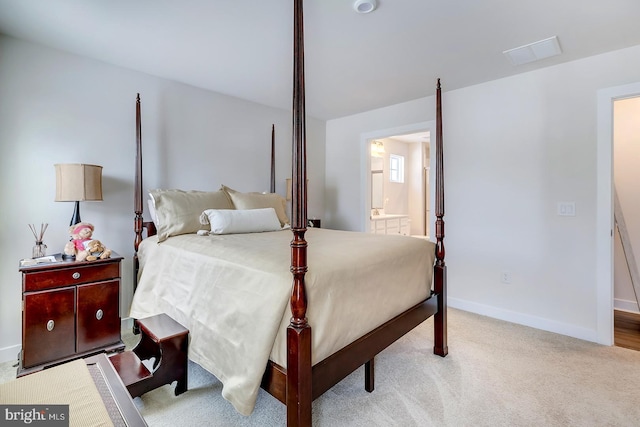 carpeted bedroom featuring ensuite bathroom