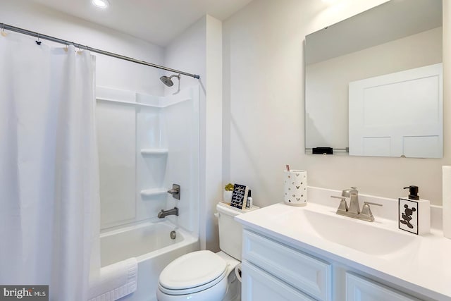 full bathroom with vanity, shower / bath combo, and toilet