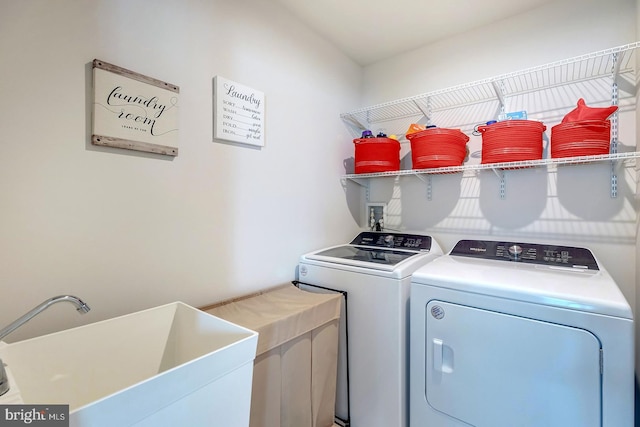 clothes washing area featuring independent washer and dryer and sink