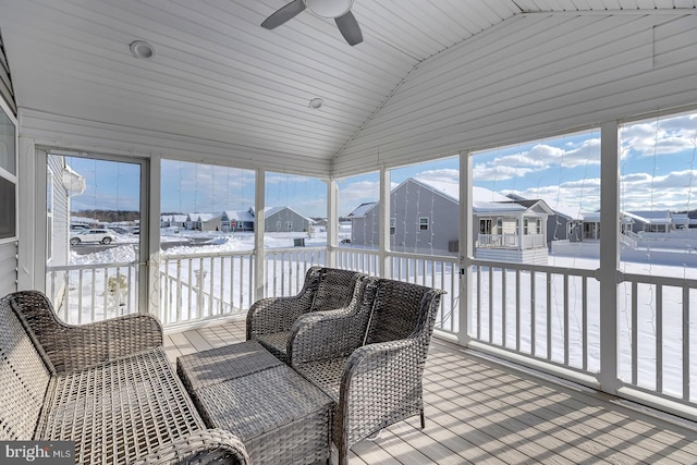 sunroom / solarium with ceiling fan and vaulted ceiling