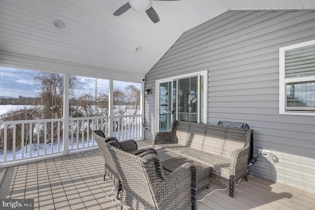 sunroom with ceiling fan and lofted ceiling