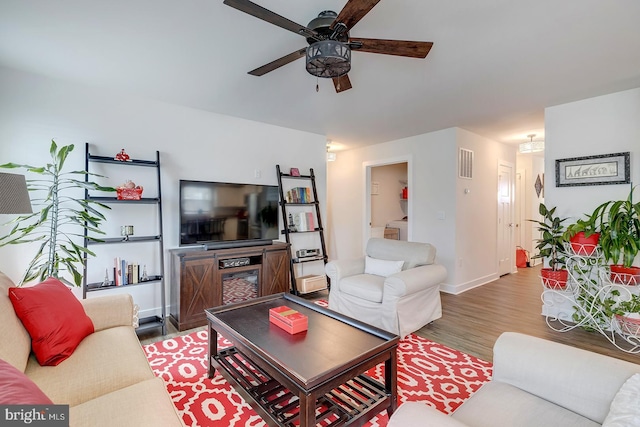 living room with wood-type flooring, washer / clothes dryer, and ceiling fan