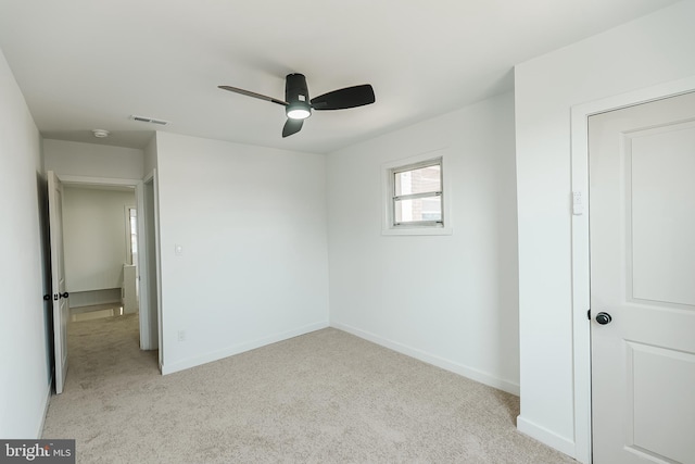 unfurnished bedroom featuring light colored carpet and ceiling fan