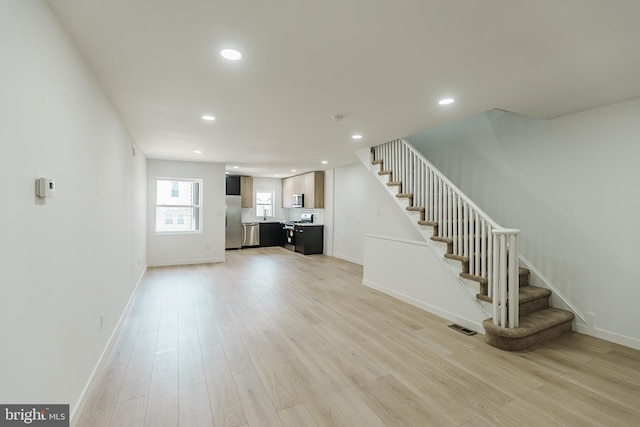 unfurnished living room featuring light wood-type flooring