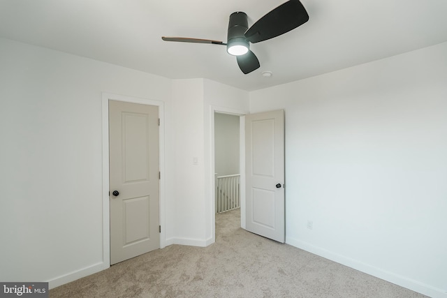 unfurnished bedroom featuring ceiling fan and light colored carpet