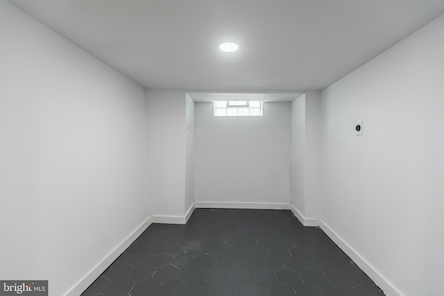 basement featuring dark tile patterned floors