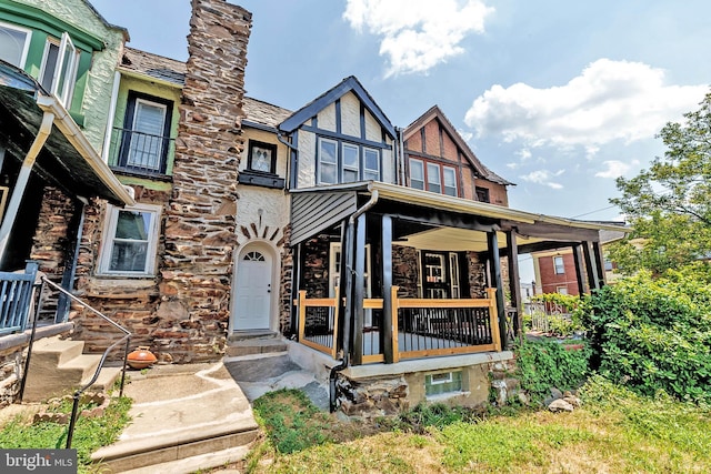 rear view of house with covered porch