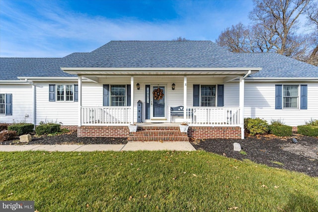 ranch-style house with a front lawn and covered porch