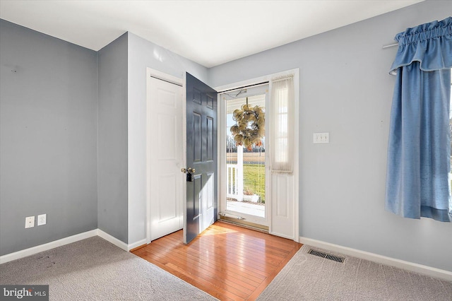 entryway with hardwood / wood-style flooring