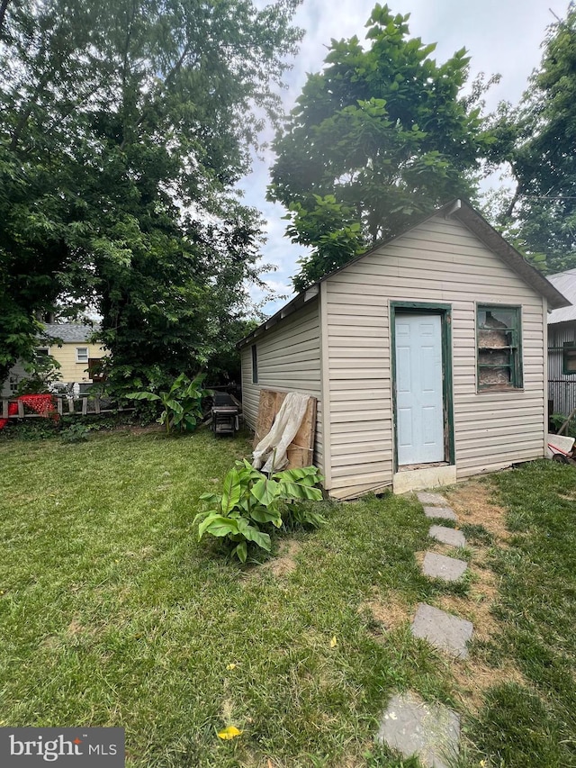 view of outbuilding featuring a lawn