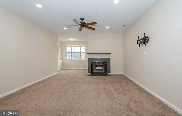 unfurnished living room with light carpet and ceiling fan