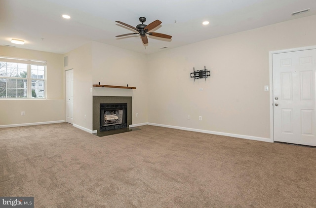 unfurnished living room with ceiling fan and carpet floors