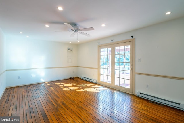 empty room with hardwood / wood-style flooring, ceiling fan, and baseboard heating