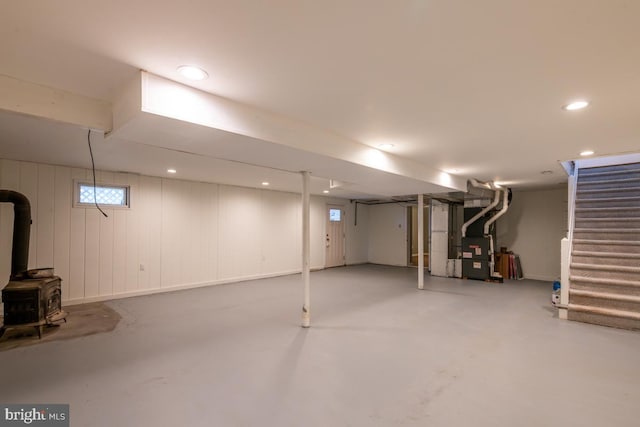 basement with heating unit and a wood stove