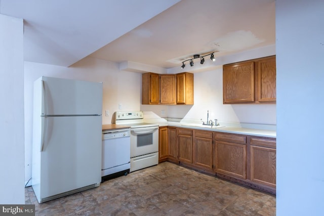 kitchen featuring white appliances and sink