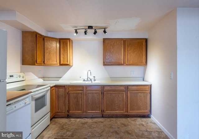 kitchen featuring white appliances and sink