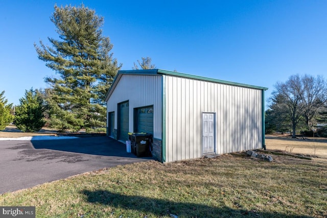 view of outdoor structure featuring a yard and a garage