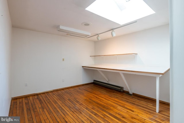 interior space featuring hardwood / wood-style flooring and rail lighting