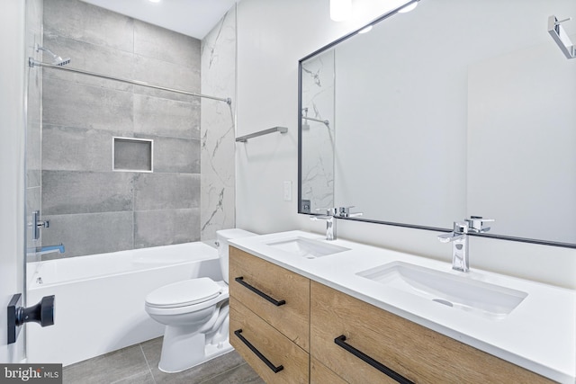 full bathroom with tile patterned floors, vanity, toilet, and tiled shower / bath combo