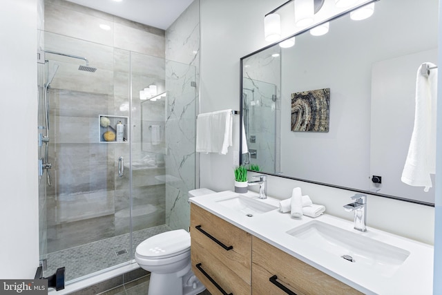 bathroom with tile patterned floors, vanity, toilet, and an enclosed shower