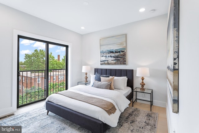 bedroom with access to outside and light hardwood / wood-style flooring