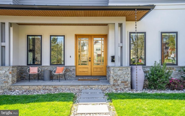 entrance to property featuring french doors and a porch