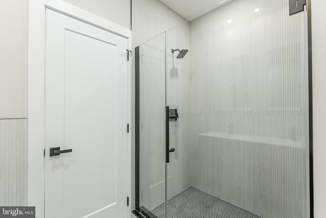 bathroom with a shower with door