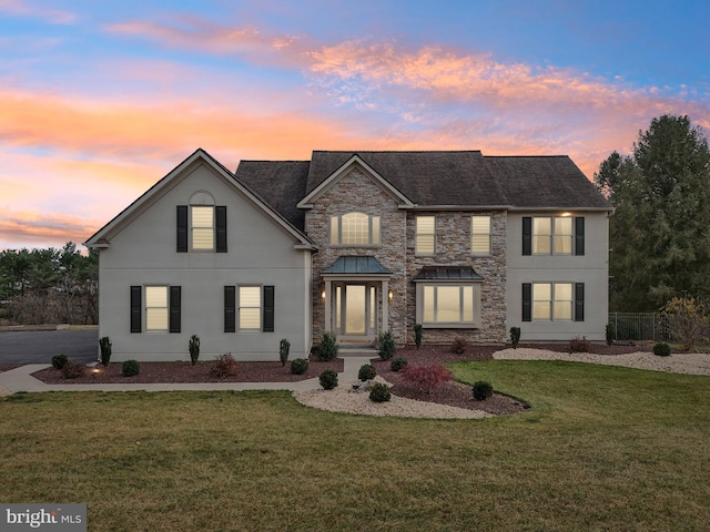 view of front of house with a yard