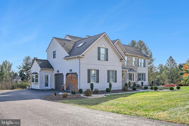 view of front facade featuring a front yard and a garage