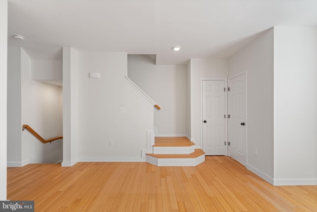 stairs with hardwood / wood-style flooring