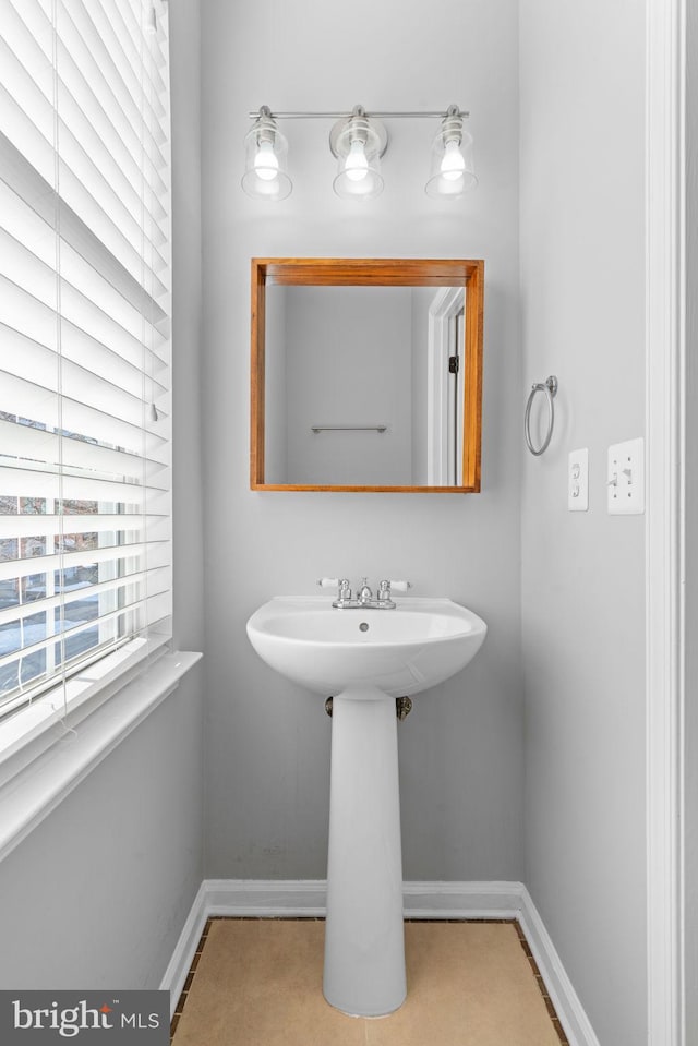 bathroom with sink and tile patterned flooring