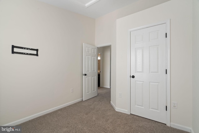 unfurnished bedroom with light colored carpet