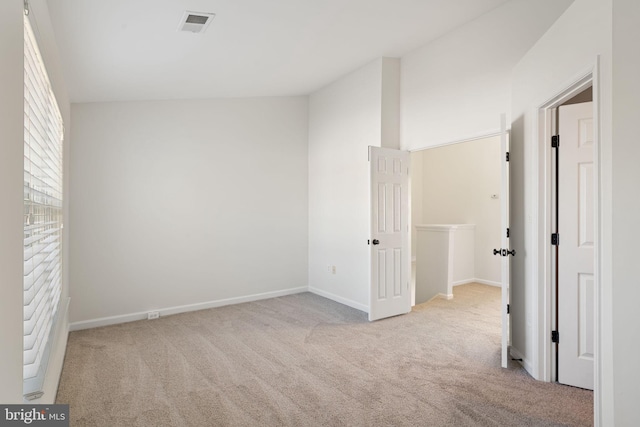 unfurnished room featuring light colored carpet