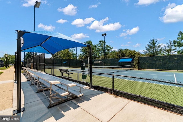 view of home's community with tennis court