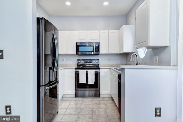 kitchen featuring white cabinets, appliances with stainless steel finishes, and sink