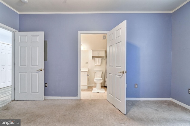 unfurnished bedroom with ornamental molding, light carpet, and ensuite bath