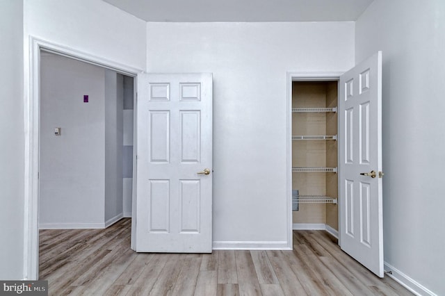 unfurnished bedroom featuring a closet and light hardwood / wood-style flooring