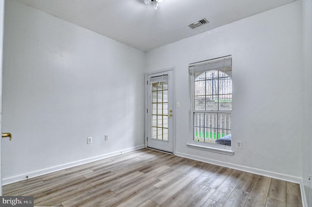 spare room featuring light wood-type flooring