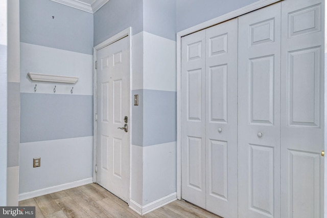 interior space with light hardwood / wood-style flooring and ornamental molding