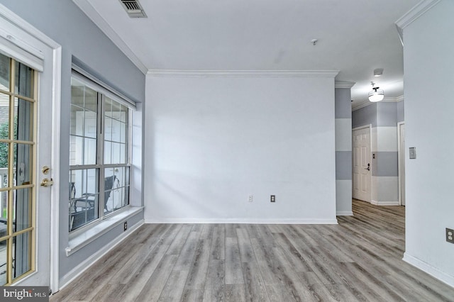 unfurnished room featuring light hardwood / wood-style flooring, a healthy amount of sunlight, and crown molding