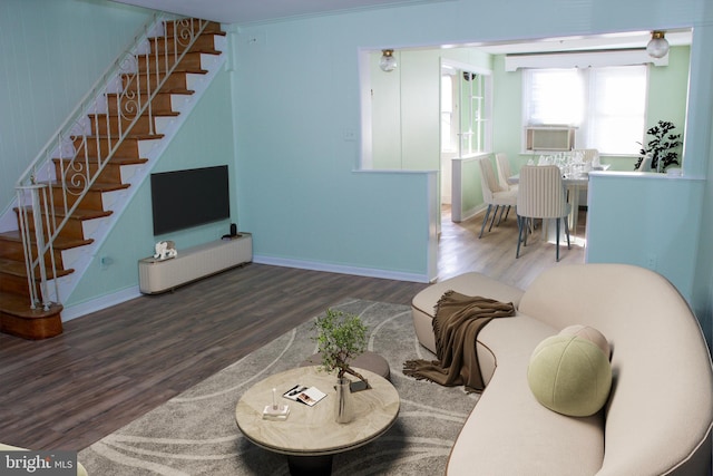 living room featuring dark wood-type flooring, ornamental molding, and cooling unit